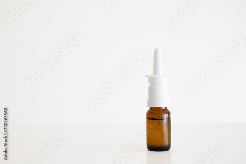 Blank brown glass nasal spray bottle with a plastic pump. Close