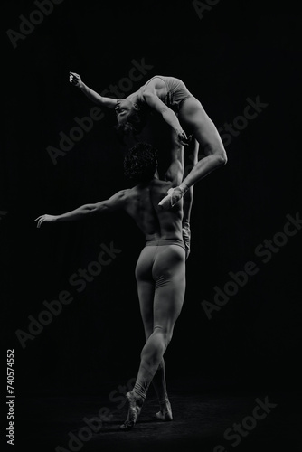 Artistic, talented and passionate ballet dancers, man and woman making fascinating performance. Monochrome. Concept of classic art, aesthetics, emotions, ballet dance, talent