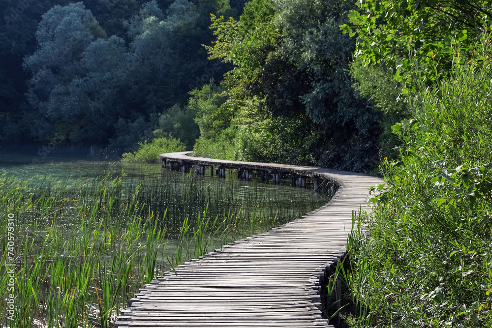 Path over a mountain lake. Plitvice lakes. Nature background. Selective focus