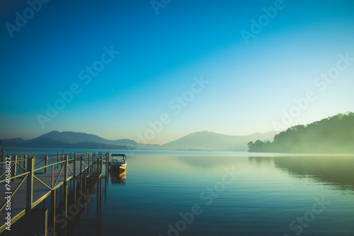 Landscape of the sun slowly rising from the mountain. Morning sunrise at Vietnam's Lak Lake.