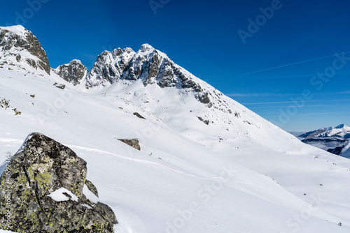 A view of a popular mountain hiking destination in the Polish Tatra Mountains, i.e Kozi Wierch (Kozi vrch, Goat Peak). Winter scenery.
