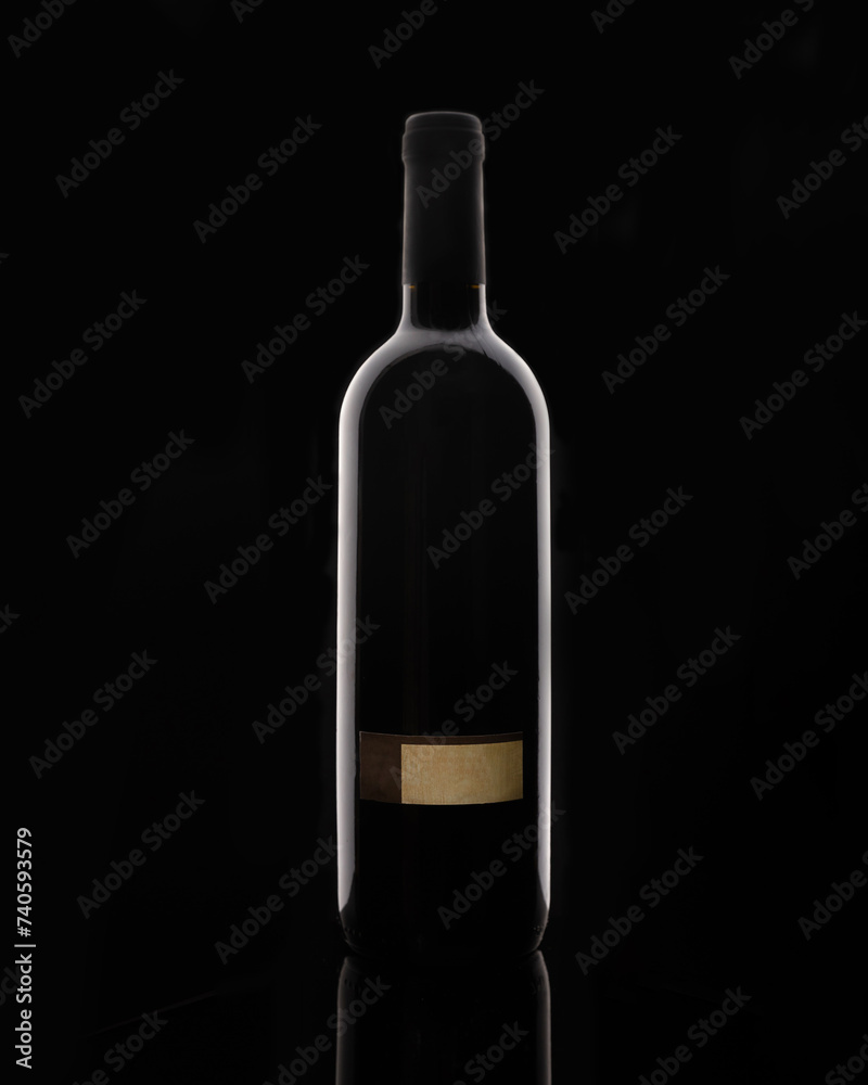 Isolated bottle of red wine on black background with blank label Isolated bottle of red wine on black background with blank label