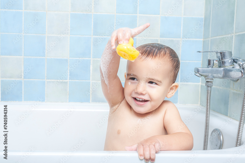 Little boy in the bathtub showing his rubber ducky to the camera Little boy in the bathtub showing his rubber ducky to the camera