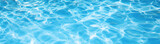 Underwater panorama of swimming pool  water with sun reflections, panoramic banner background