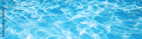 Underwater panorama of swimming pool  water with sun reflections, panoramic banner background photo