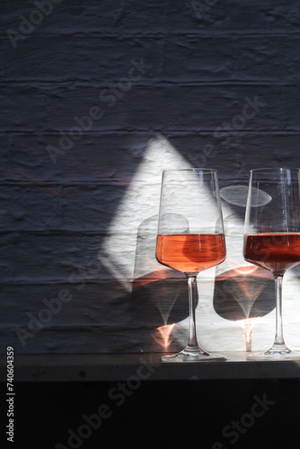 A glass with rose wine and a bottle