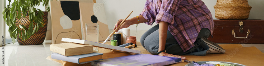 Fototapeta premium Web banner with creative girl painting picture on canvas at home