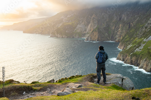 Tourist at Slieve League, Irelands highest sea cliffs, located in south west Donegal along this magnificent costal driving route. One of the most popular stops at Wild Atlantic Way route. photo