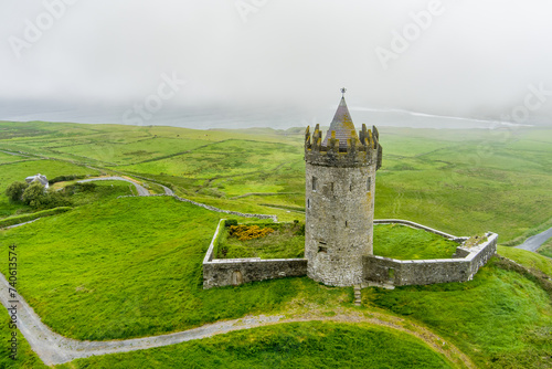 Doonagore Castle, round 16th-century tower house with a small walled enclosure located near the coastal village of Doolin in County Clare, Ireland. photo