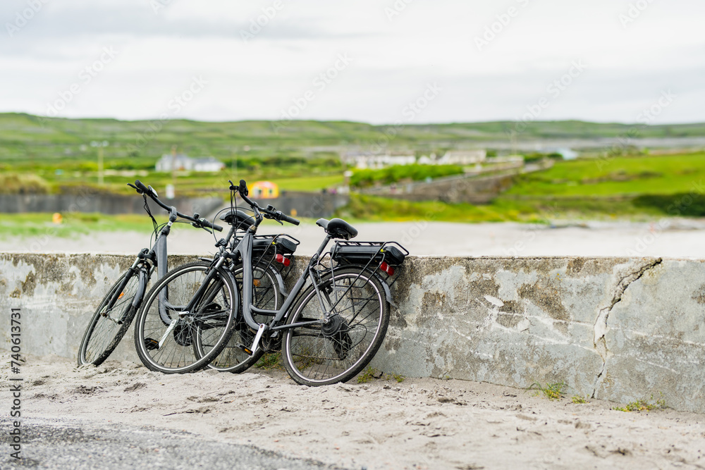 Two electric bikes parked on Inishmore, the largest of the Aran Islands in Galway Bay. Renting a bicycle is one of the most popular way to get around Inis Mor, Ireland.