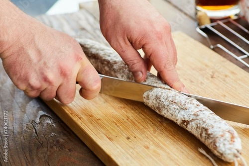 Slicing dried sausage into thin slices. Preparation of sandwiches or dishes based on this product. The process of making food