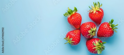 Top view of fresh red strawberry pile against vibrant background, healthy eating concept