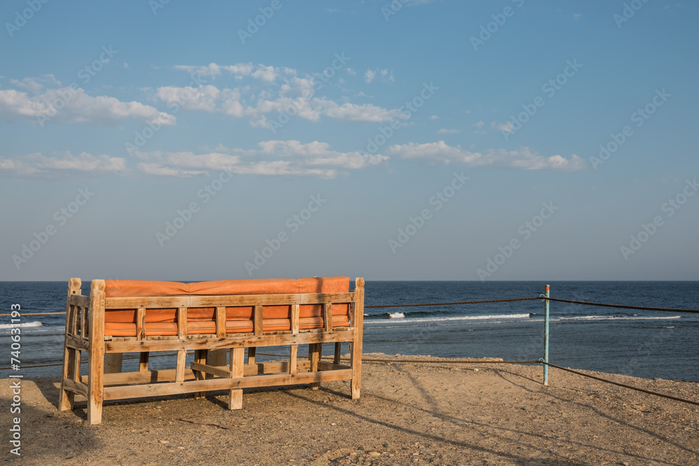 cozy bench at the highest place from the beach with a wonderful view to the sea