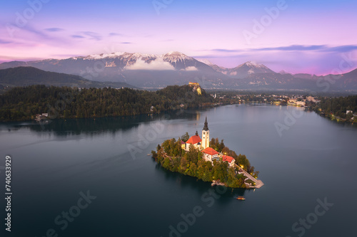 Elevated view with panoramic blue hour dusk night of Lake Bled Island Blejsko jezero with Bled city lights and Julian alps in the background, Bled, Upper Carniola, Slovenia photo