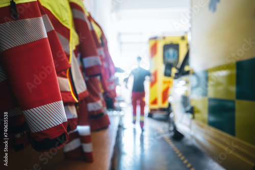 Selective focus on paramedic uniform of emergency medical service. Paramedic running to ambulance car. Themes emergency medicine, rescue, and emergency help.. photo