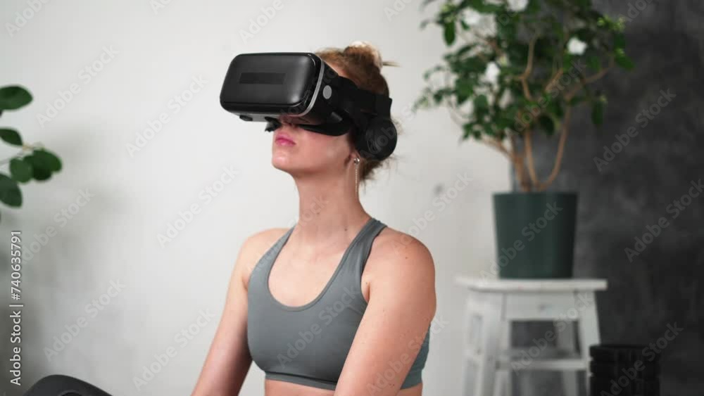 A woman wearing a virtual reality headset sits on a yoga mat, surrounded by plants and trees, with her body in a relaxed posture. A woman wearing a virtual reality headset sits on a yoga mat, surrounded by plants and trees, with her body in a relaxed posture.