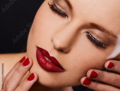 Beauty  cosmetics and face of woman with manicure  relax and lipstick for creative studio aesthetic. Luxury makeup  skincare and hands with red nail polish for self care  shine and black background