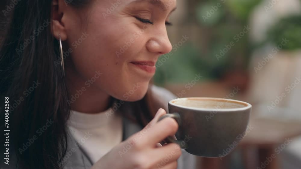 Closeup of a young woman savoring a coffee at a cafe, with a big mug in hand, embodying relaxation and pleasure. Closeup of a young woman savoring a coffee at a cafe, with a big mug in hand, embodying relaxation and pleasure.