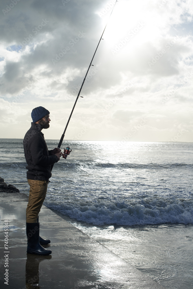 Thinking, fishing and man at a beach with pole for water hobby, recreation or stress relief vacation in nature. Casting, rod and fisherman at sea for travel, adventure or fisher sports in Cape Town Thinking, fishing and man at a beach with pole for water hobby, recreation or stress relief vacation in nature. Casting, rod and fisherman at sea for travel, adventure or fisher sports in Cape Town