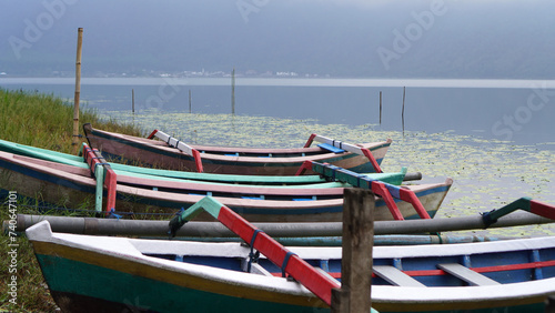 Colorful wooden fishing boats in the edge of the lake. Beratan Lake Bedugul, Bali, Indonesia © Maria Marganingsih