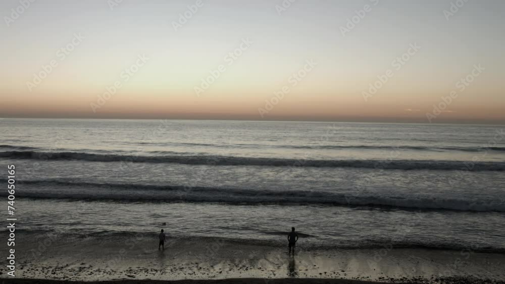 A family play on the beach during a sunset in Carlsbad, California-near San Diego. A family play on the beach during a sunset in Carlsbad, California-near San Diego.