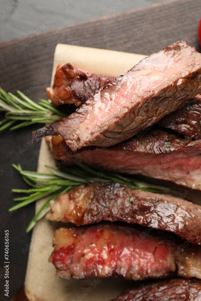 Delicious grilled beef with rosemary on table, top view