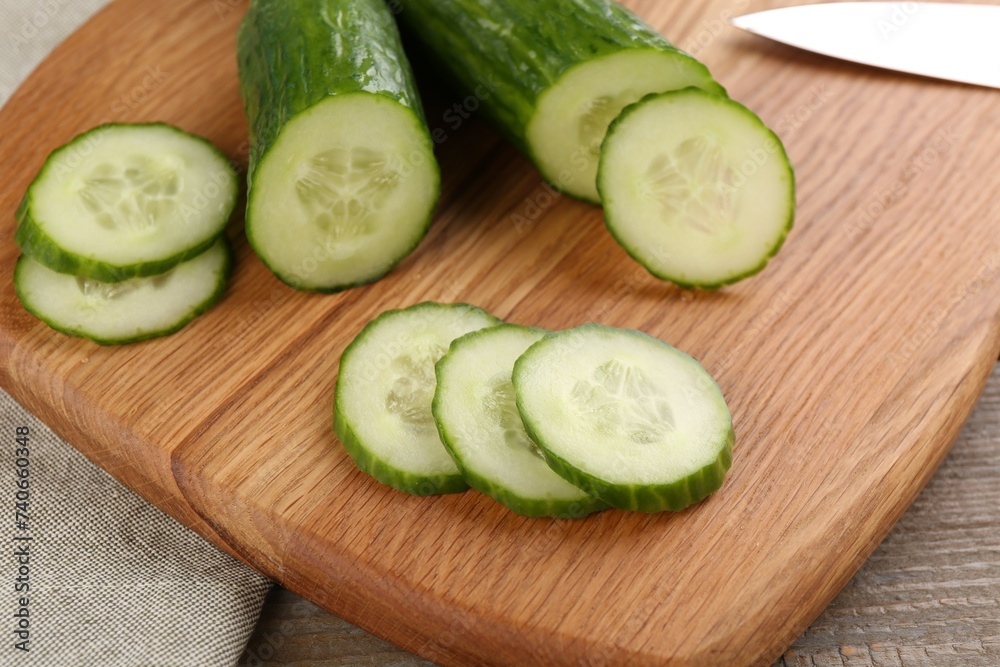Cucumbers. knife and cutting board on table, closeup Cucumbers. knife and cutting board on table, closeup