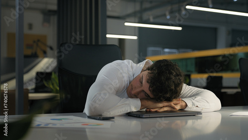 Tired exhausted Caucasian businessman finish work night evening office sleeping relax on computer on table need sleep insomnia disorder fatigued male overworked overtime working business man deadline