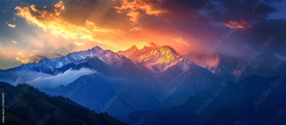 A stunning natural landscape with a mountain range silhouetted against the colorful sunset sky. Cumulus clouds drift in the atmosphere, reflecting the warm hues of dusk over the tranquil water below - obrazy, fototapety, plakaty 