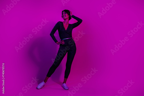 Full body photo of attractive young woman posing look empty space wear trendy overall clothes isolated on neon light pink color background