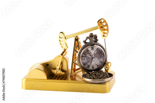 Golden miniature oil pump and vintage pocket watch on white background