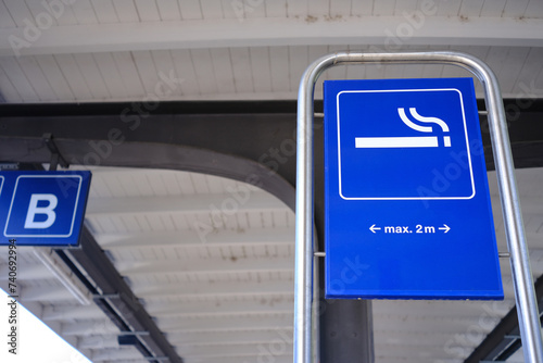 Smoking zone sign in public area.