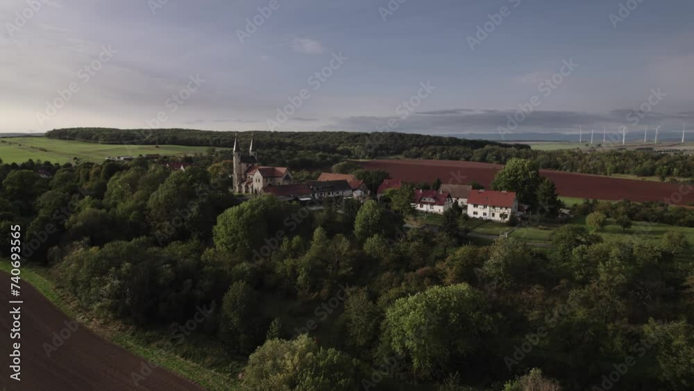 Drone flight in autumn over a small village in Munchenlochra Germany. The fields are yellow and green and the sun is going down. Drone flight in autumn over a small village in Munchenlochra Germany. The fields are yellow and green and the sun is going down.