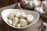 Fresh garlic cloves and bulbs on table, closeup