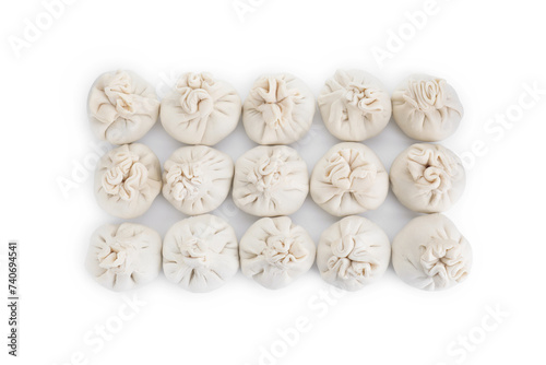 Many uncooked khinkali (dumplings) isolated on white, top view. Georgian cuisine