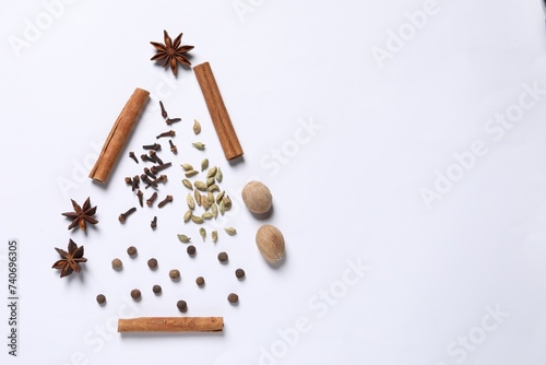 Christmas tree made of different spices on white table, flat lay. Space for text