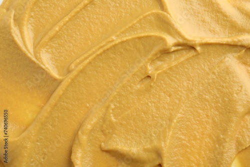 Fresh tasty mustard sauce as background, top view