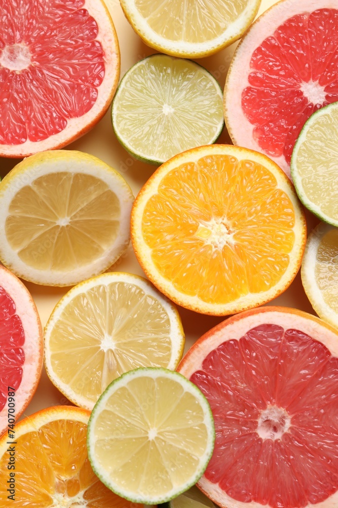 Different cut citrus fruits on beige table, flat lay Different cut citrus fruits on beige table, flat lay