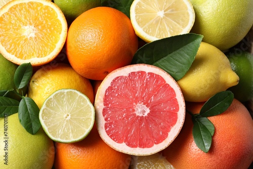 Fototapeta Naklejka Na Ścianę i Meble -  Different cut and whole citrus fruits as background, top view