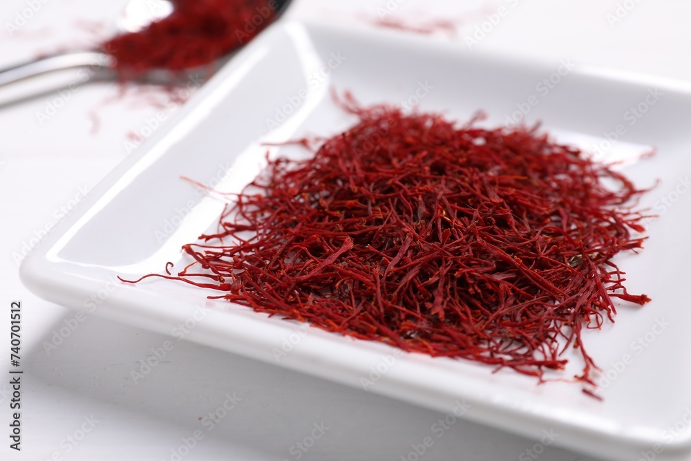 Fototapeta premium Aromatic saffron on white table, closeup view