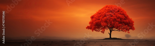 A solitary tree adorned with fiery red leaves stands tall amidst the barren desert landscape, offering a stark contrast against the arid surroundings. Empty space and place for text