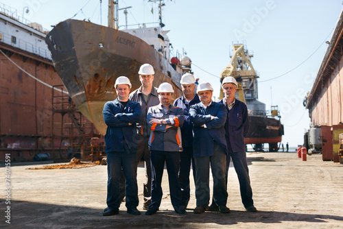 Fényképezés Team of shipyard workers stand proudly at dry dock