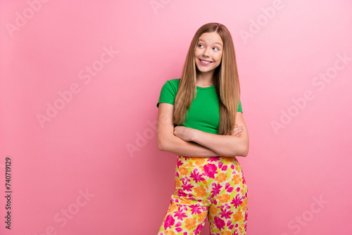 Photo portrait of lovely teen lady crossed hands look empty space wear trendy green garment isolated on pink color background