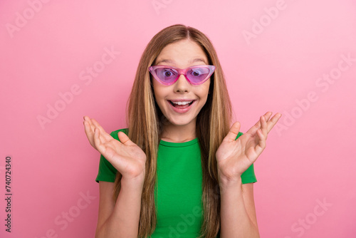 Photo of cute adorable girl wear green stylish raise arm cant believe imagine rejoice special offer news isolated on pink color background
