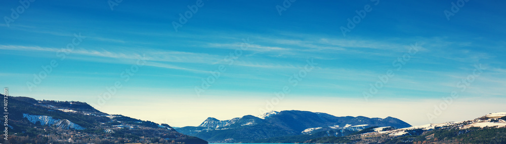 View of the mountains around Serre Poncon lake in winter. Hautes Alpes, France. Horizontal banner