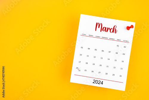 March 2024 calendar page with red push pin on yellow.