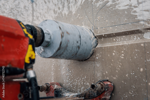 Drilling a hole into a concrete wall with core driller
