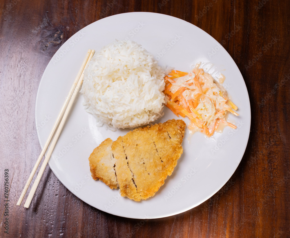 Rice with chicken katsu in white plate on wooden table. After some edits. Rice with chicken katsu in white plate on wooden table. After some edits.