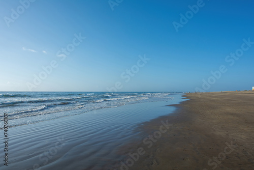 Sandy beach by the sea with waves