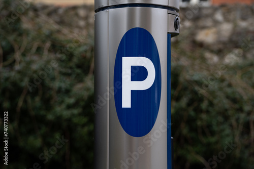 Parking meter, Parkometr or Parkomat in paid parking zone of city centre downtown district. Car park pay and display ticket machine. photo